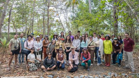 A group photo of Fellowship to Friendship participants standing in the forest.